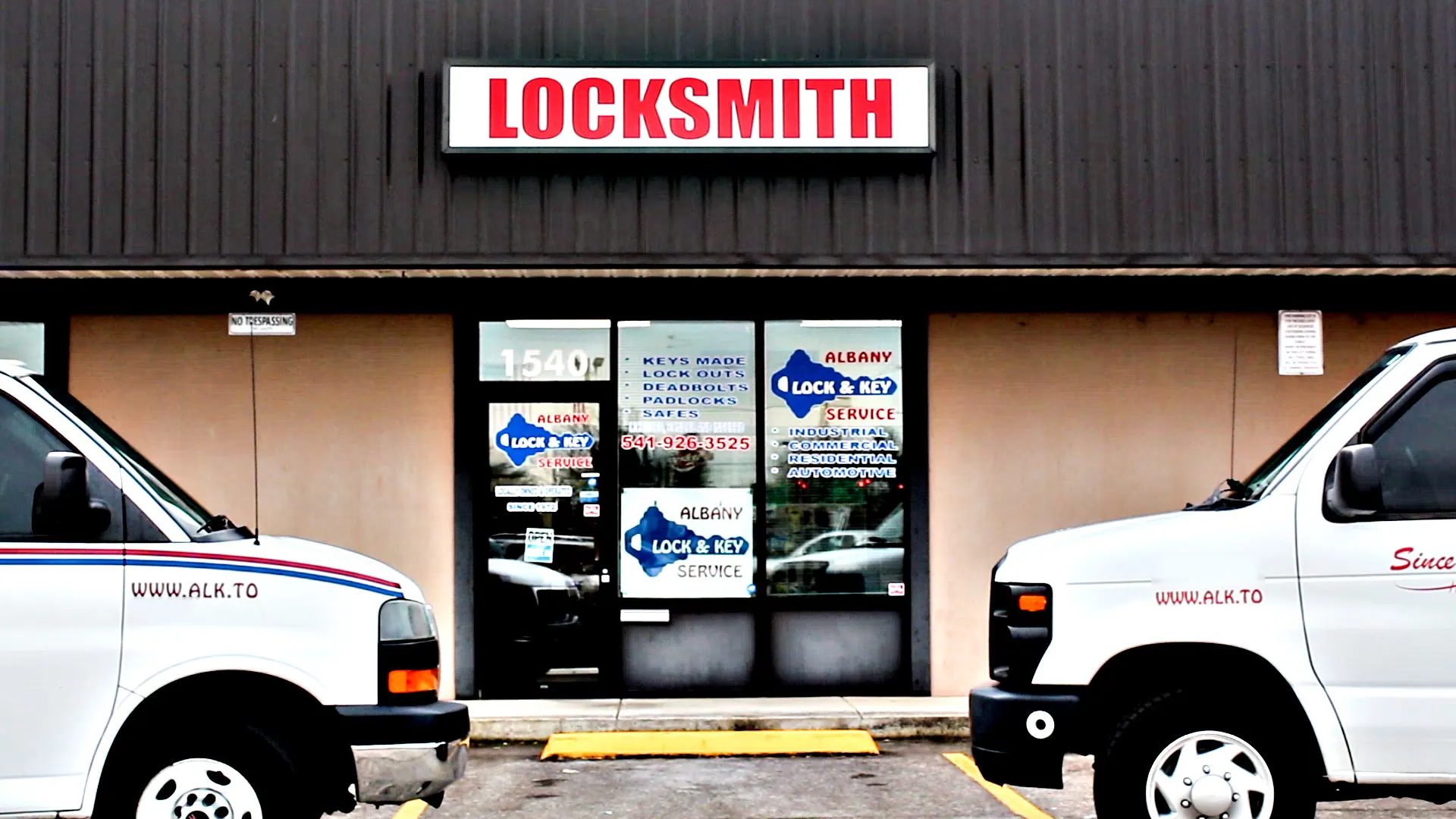 Albany Lock and Key storefront at 1540 SE 9th Ave, Albany, with two service vans parked out front