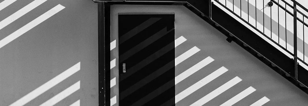 Steel door under an exterior stairway on a commercial building